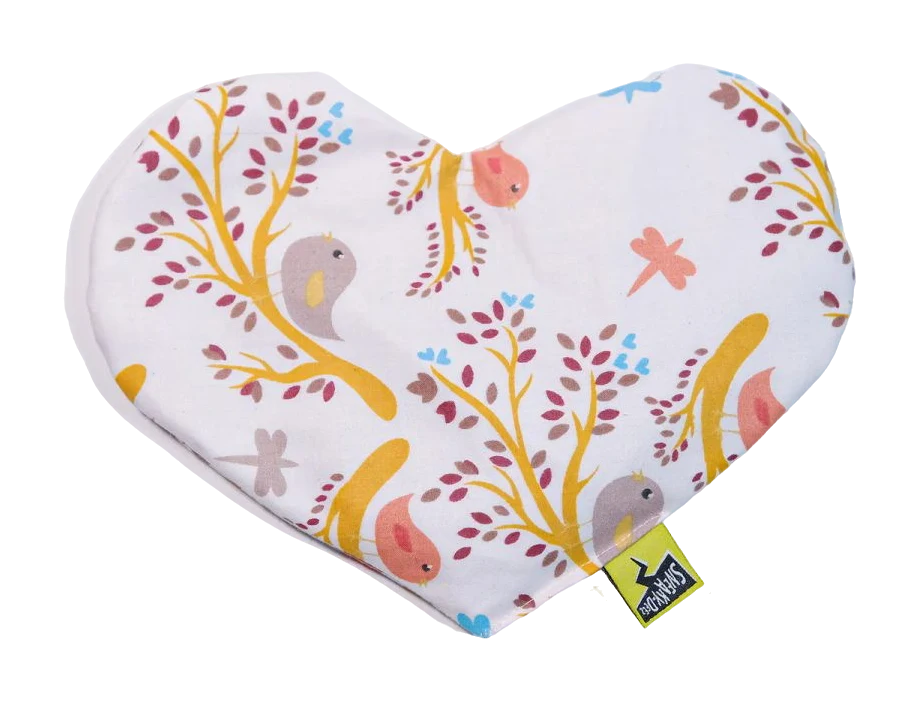 A heart-shaped SneakyDeez heat pack in cream cotton printed with little birds, branches and dragonflies
