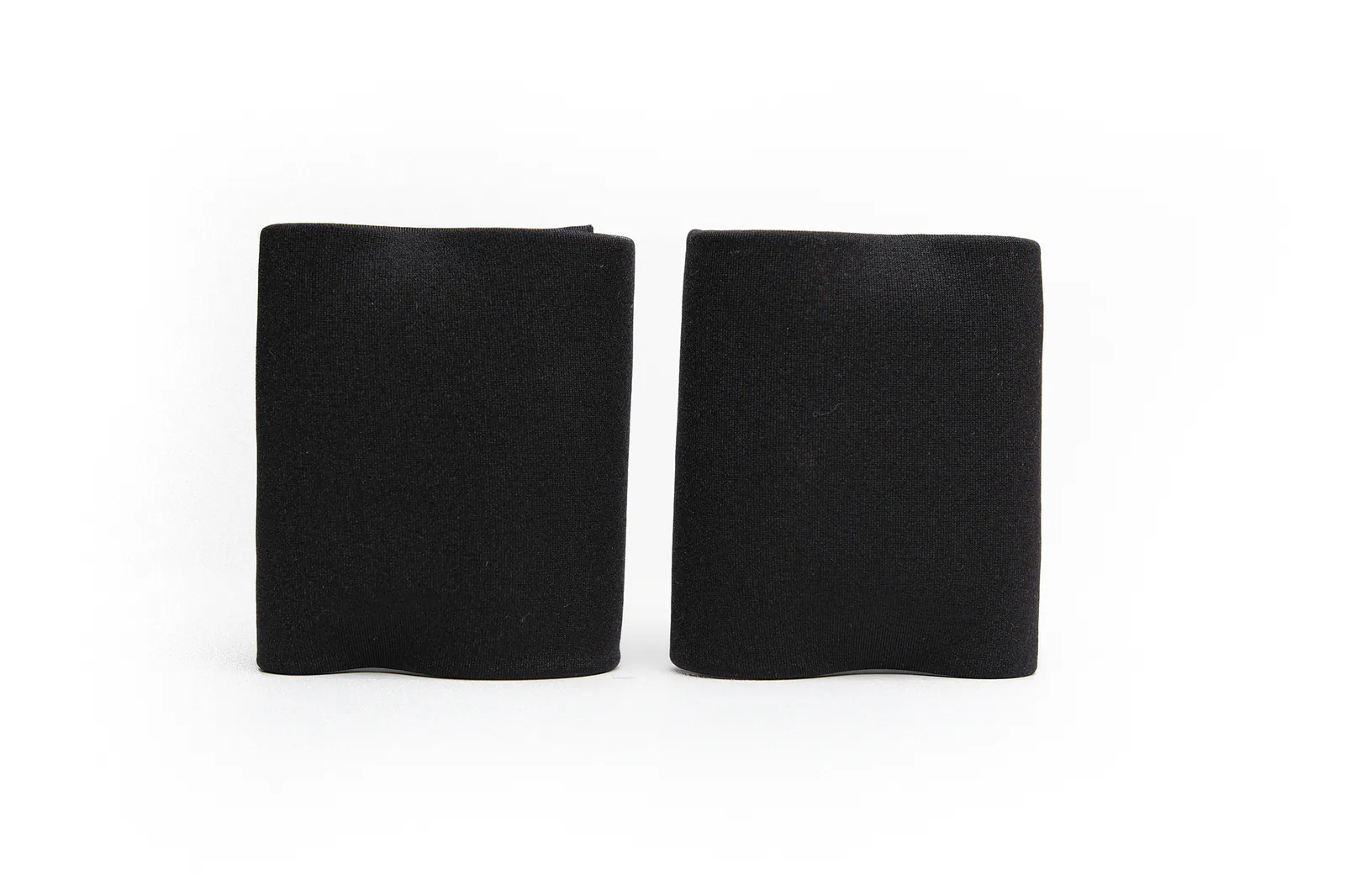 A pair of plain black 8 cm wide wrist wraps standing side by side on a white background